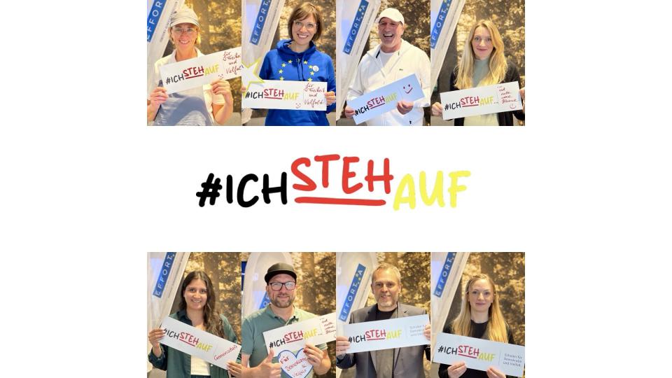 Abgebildet sind mehrere Personen, die jeweils einen Zettel mit der Aufschrift "#IchStehAuf" in die Kamera halten. 
